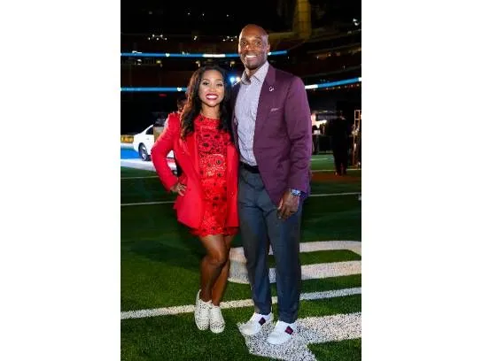 DeMeco and Jamila Ryans together on a football field